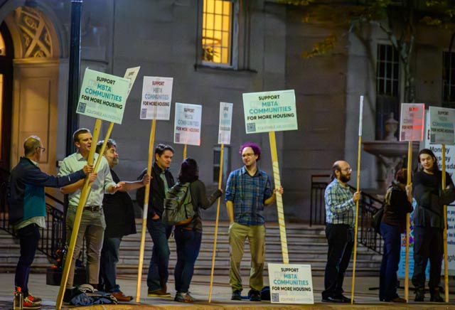 Equitable Arlington members demonstration outside of Arlington Town Hall in support of the MBTA Communities proposal