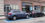 A station wagon parked in a handicap space.  The space is painted blue, with a white border.